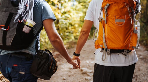 A couple takes a hike while holding hands