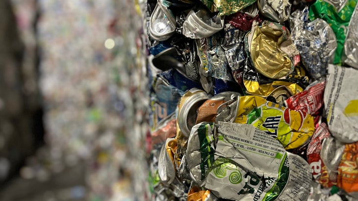 bales of crushed cans at a recycling center