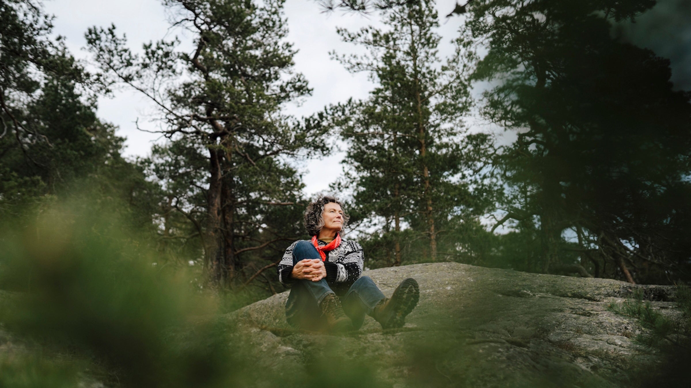 Hiker forest bathing on a rock