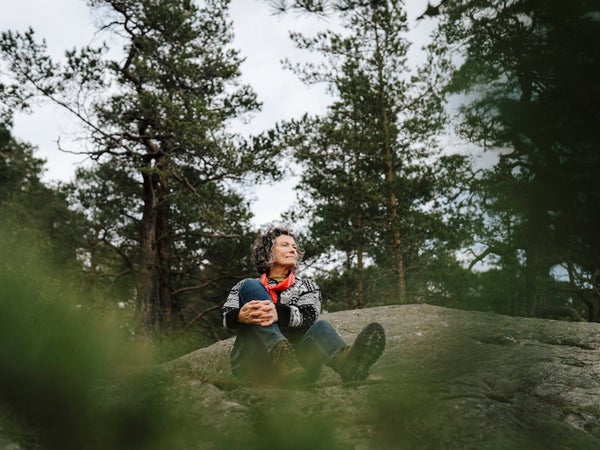 Hiker forest bathing on a rock