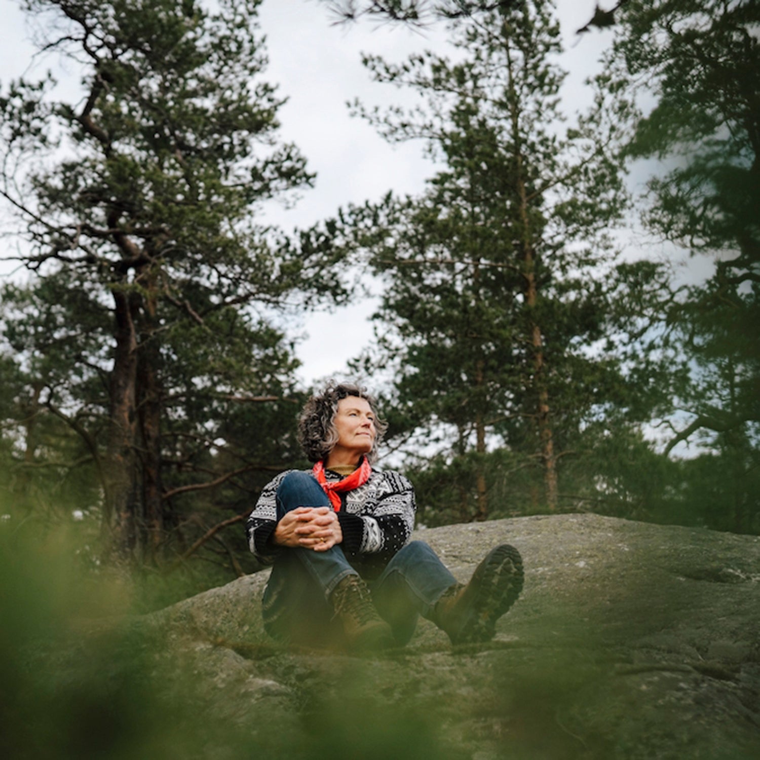 Hiker forest bathing on a rock