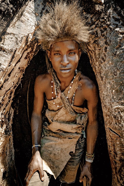 A young Hadza hunter in a baobab tree