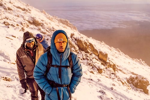 King followed by two guides on the final ascent