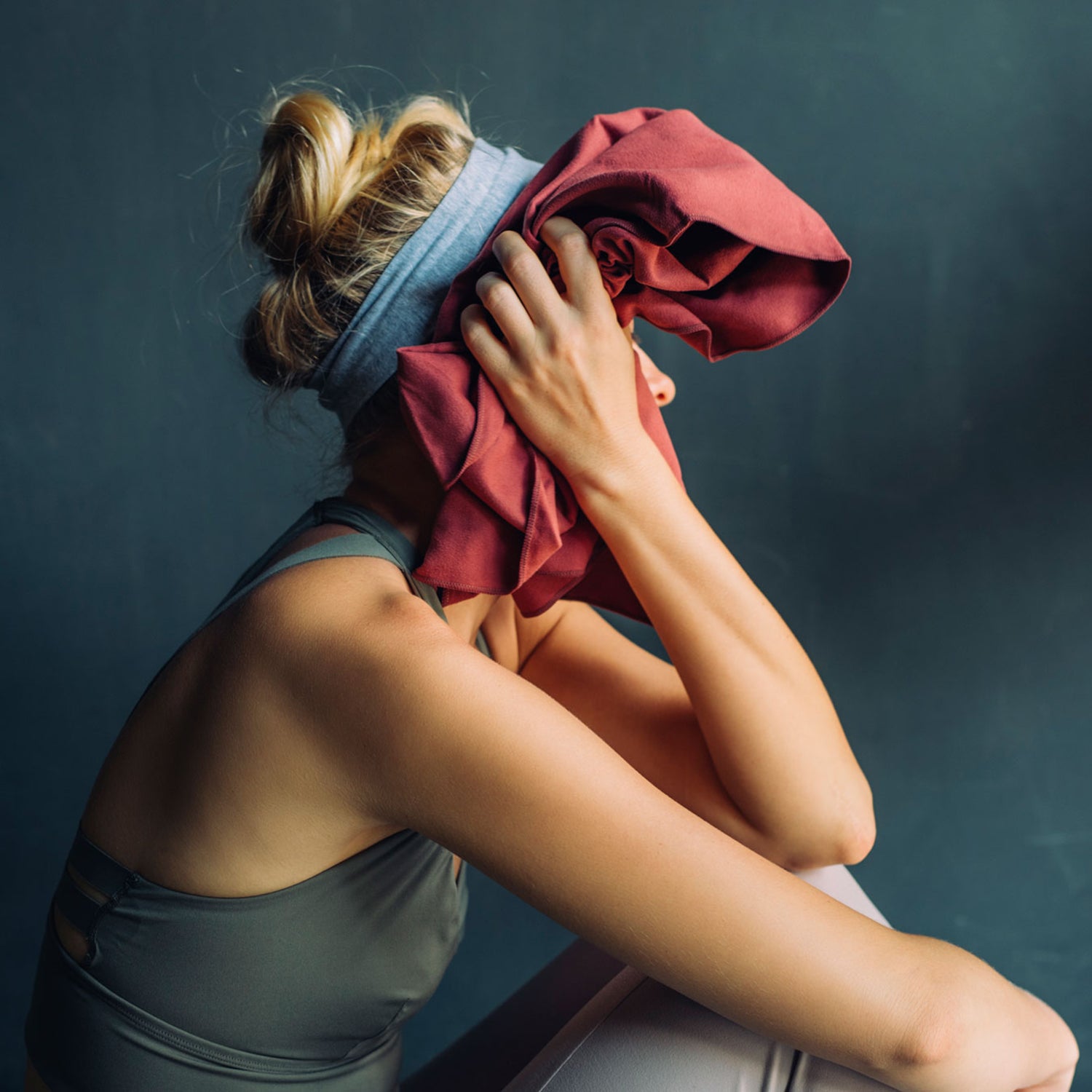 Woman wipes her face after difficult workout class