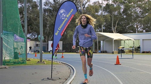 camille herron runs around a track to complete her world record