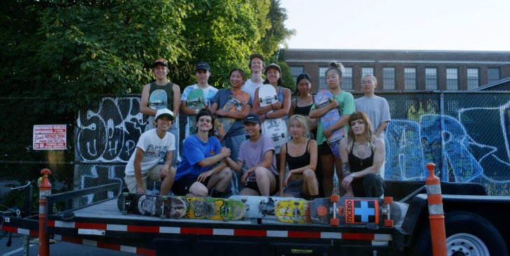 A group of skateboarders pose for the camera