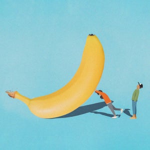 two small people and big banana
