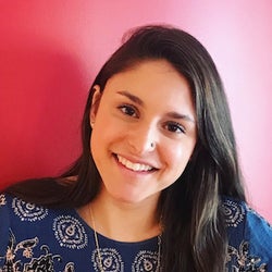 emma zimmerman headshot in front of a red background