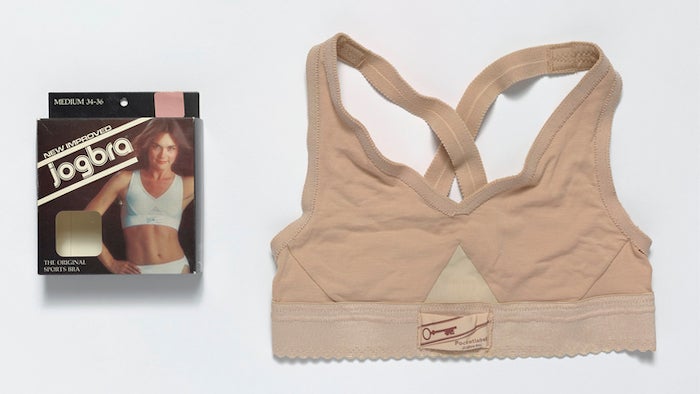 An aerial layout of the first sports bras with the packaging on a white background