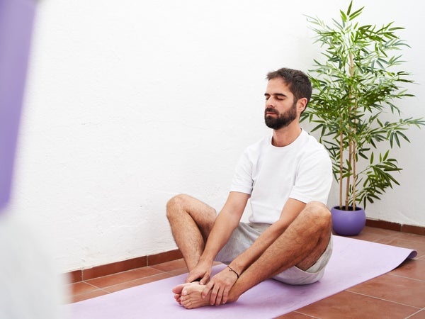 Man stretches his hips in a butterfly stretch
