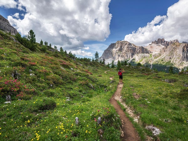 A woman spends time hiking outdoors for her health