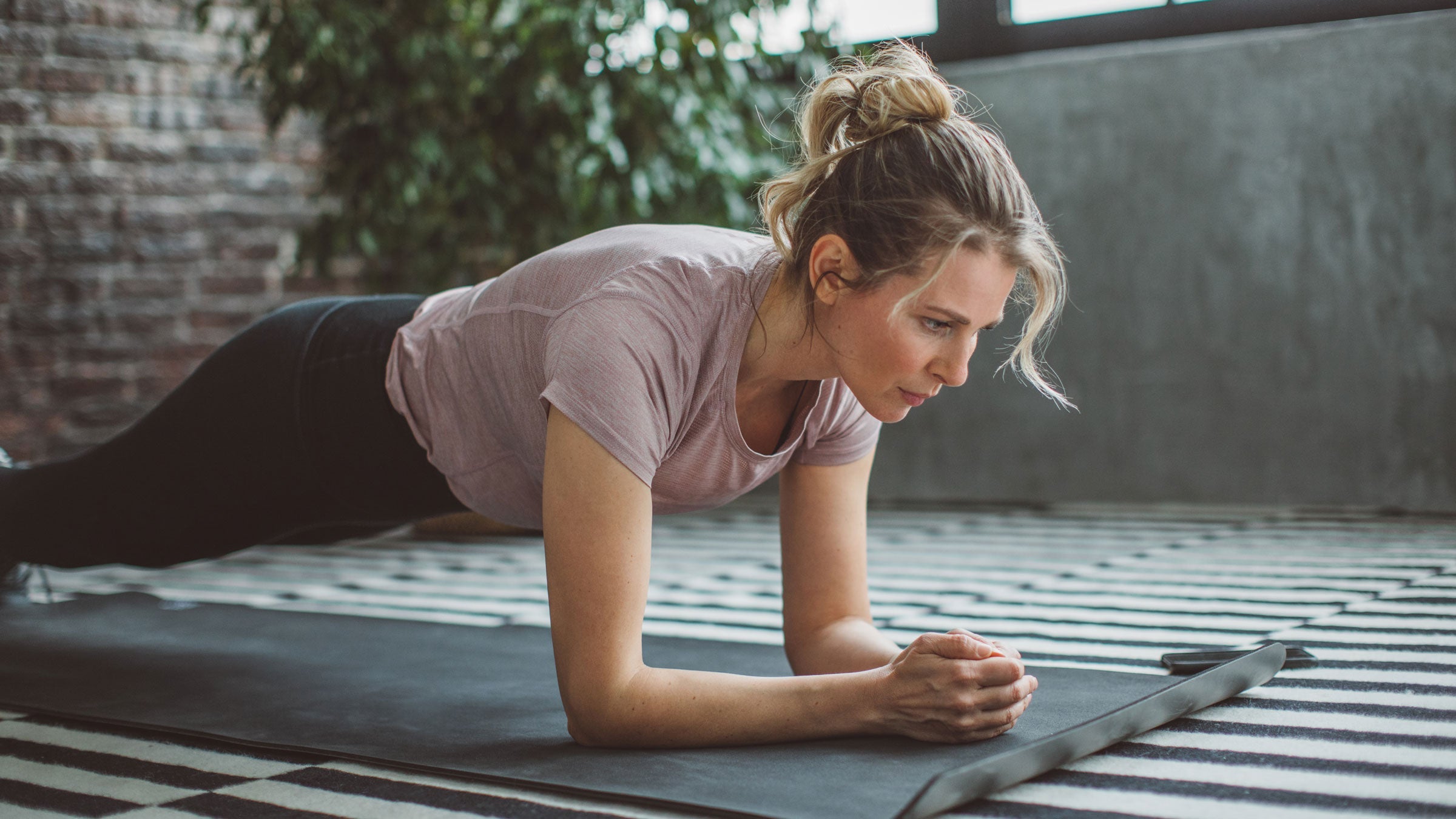 Woman in forearm plank pose during a core workout