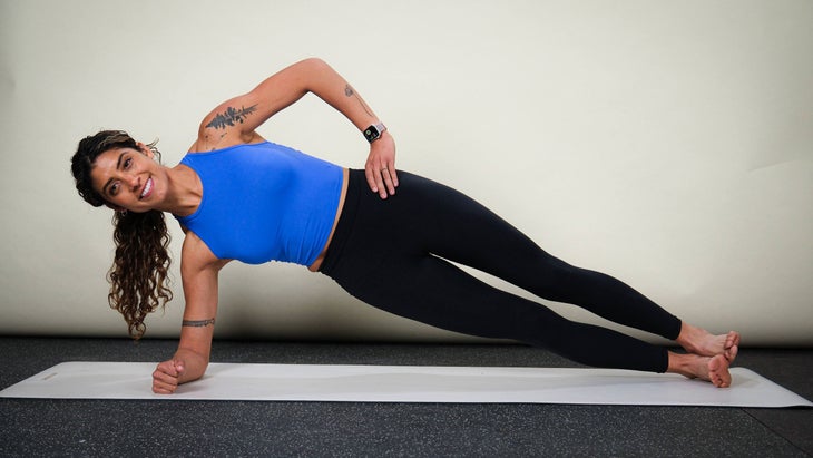 A woman demonstrates a side plank for a core workout