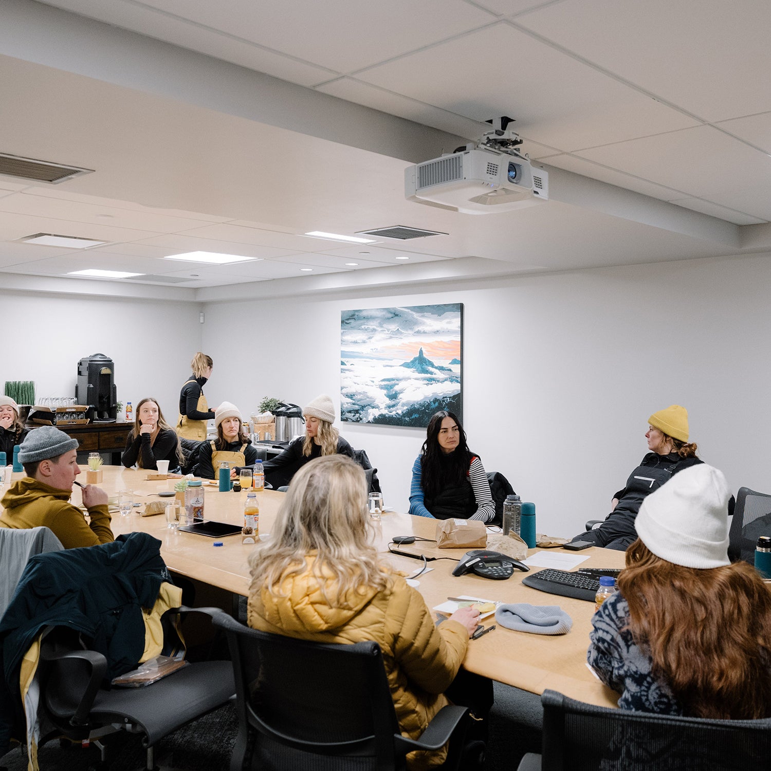 Women from Arc’teryx sitting around a conference room table