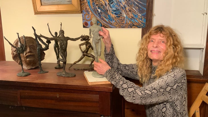 Bobbi Gibb poses with her sculptures