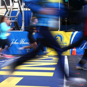 Several runners cross the finish line of the Boston Marathon