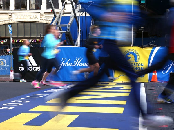Several runners cross the finish line of the Boston Marathon