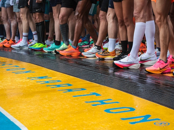 Various multicolored running shoes at the start of the 2023 Boston Marathon