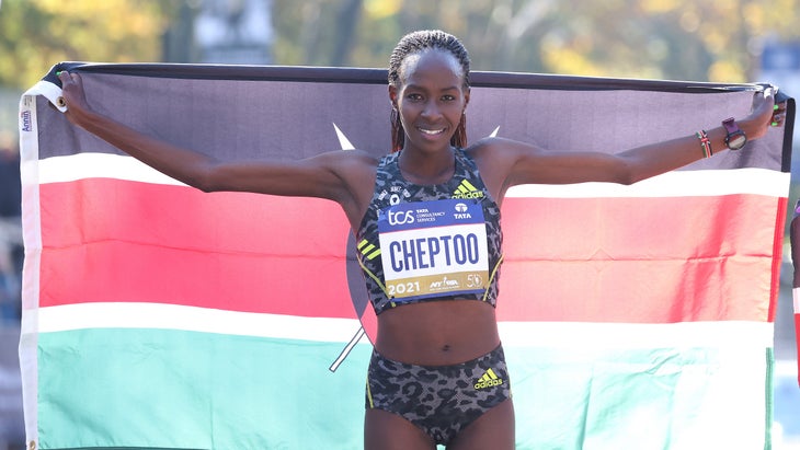 Cheptoo holds up a Kenya flag after finishing the NYC marathon