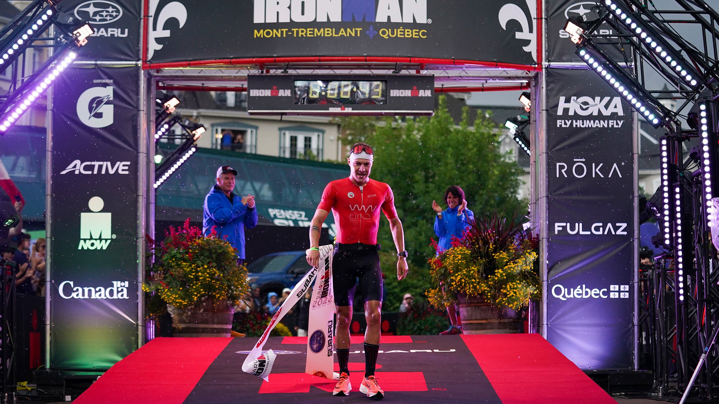 Collin Chartier of the United States celebrates after finishing in first place in the IRONMAN Mont-Tremblant on August 21, 2022