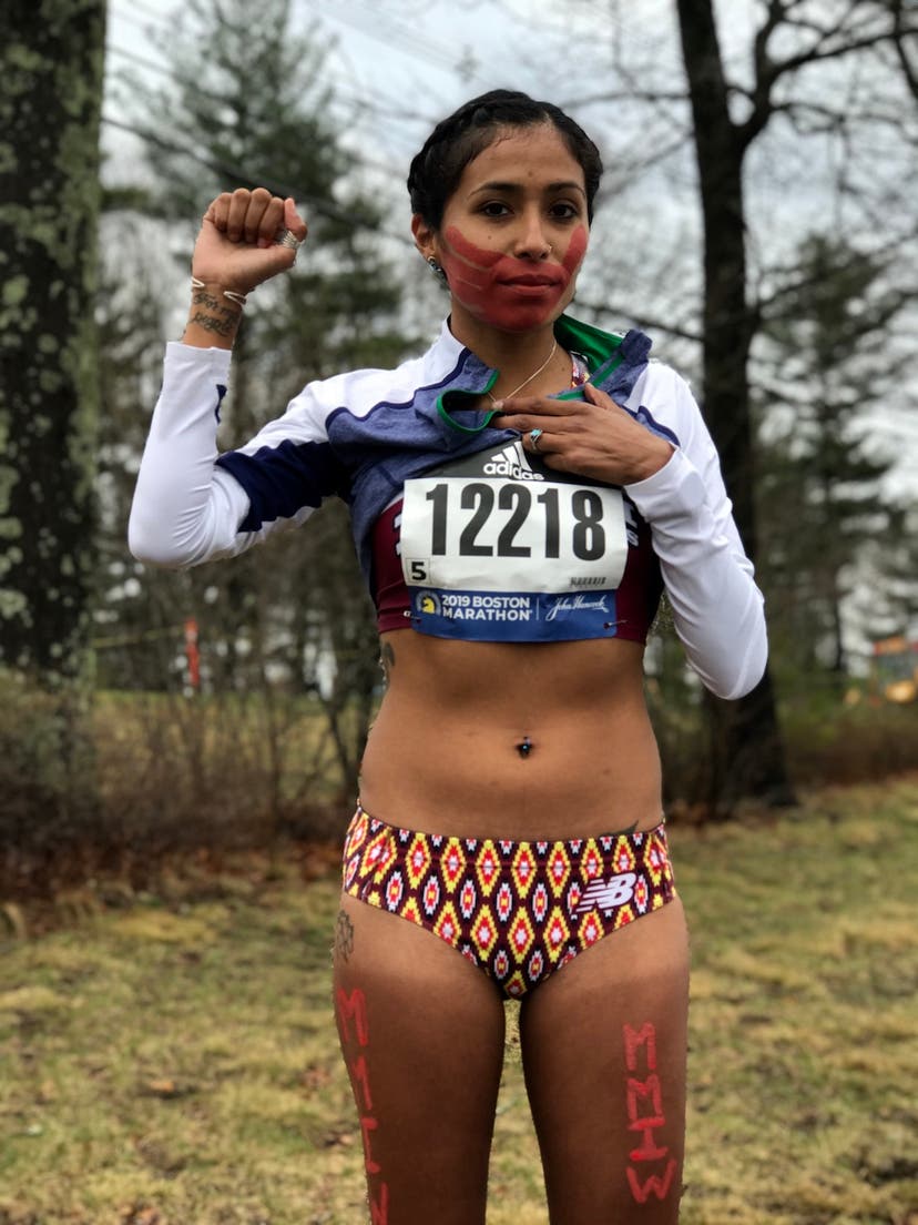 Jordan Daniels holds up a fist during her prayer run at Boston