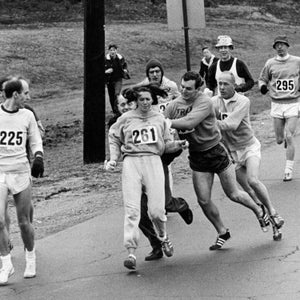 Kathrine Switzer, of Syracuse, N.Y., center, was spotted early in the Boston Marathon by Jock Semple, center right, who tried to rip the number off her shirt and remove her from the race. Switzer's friends intervened, allowing her to make her getaway to become the first woman to 
