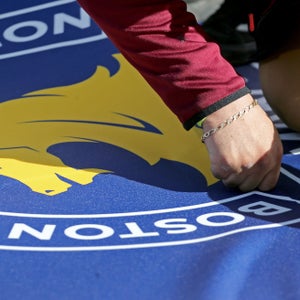 Workers prepare the Boston Marathon finish line.