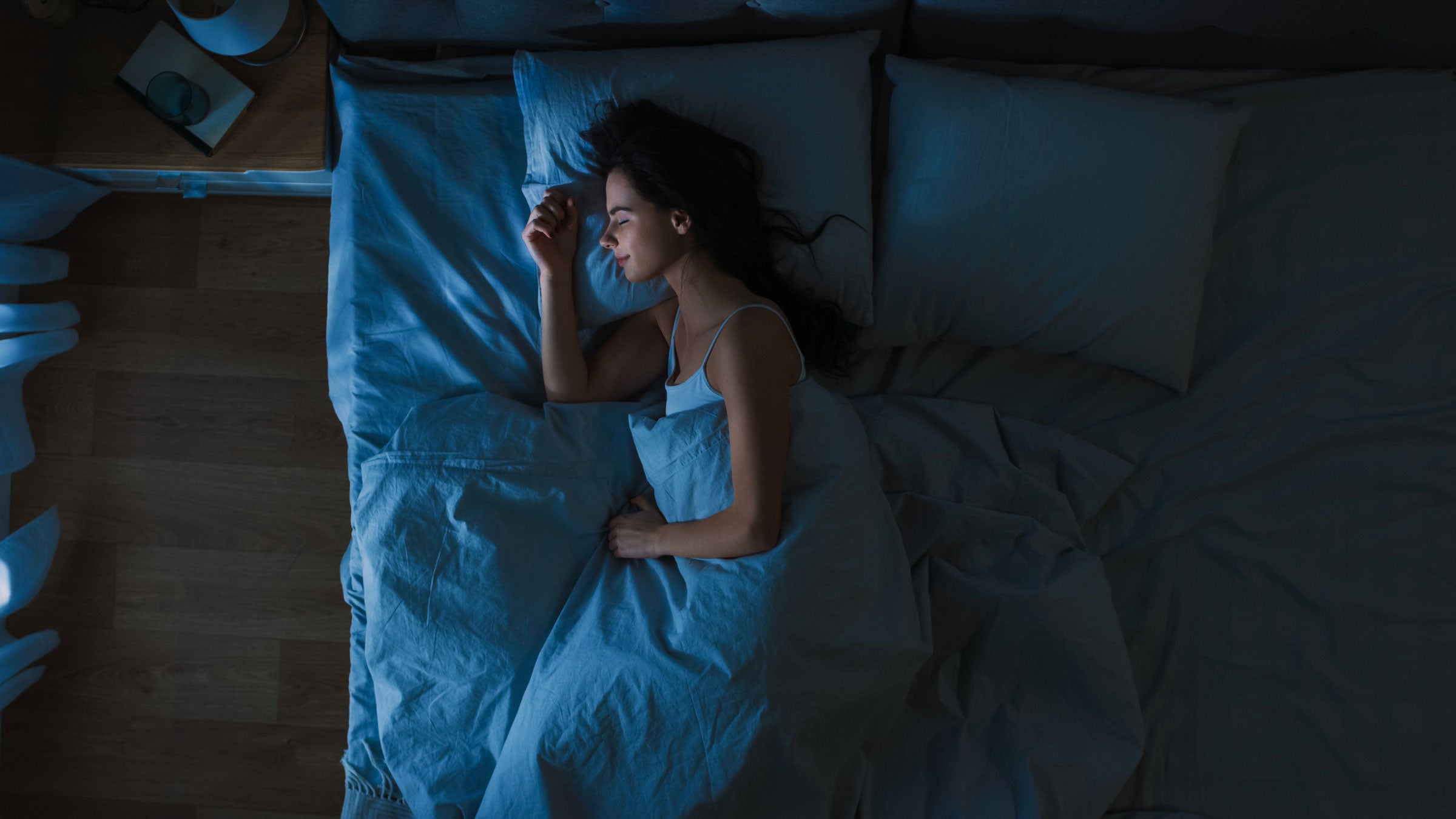 Woman sleeps on a bed at night