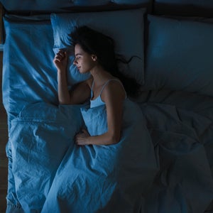 Woman sleeps on a bed at night