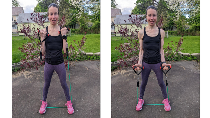 Woman demonstrates a bicep curl during a resistance band arm workout
