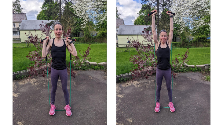 Woman demonstrates an overhead press during a resistance band arm workout
