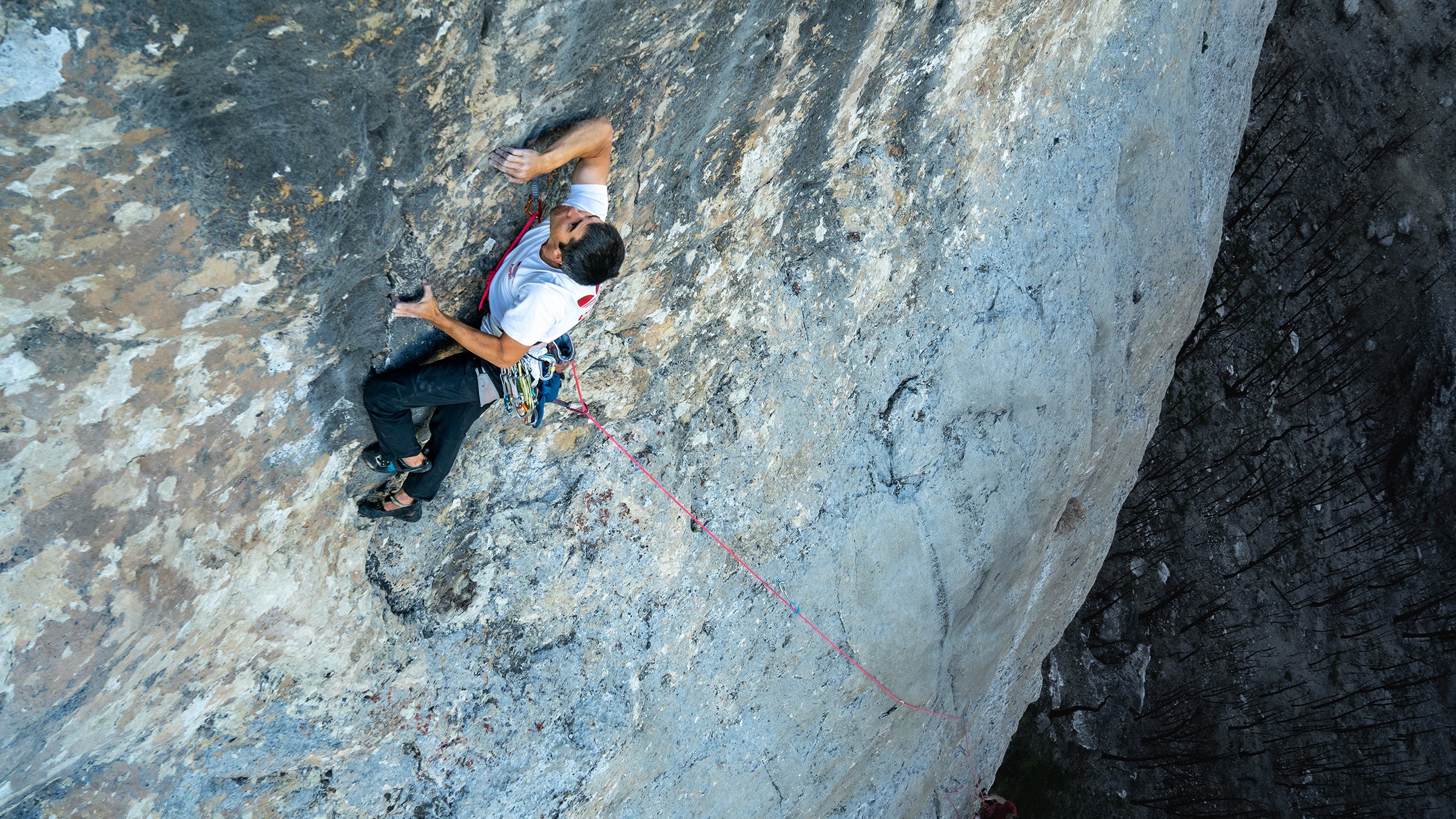Climber with hardware attached to a harness