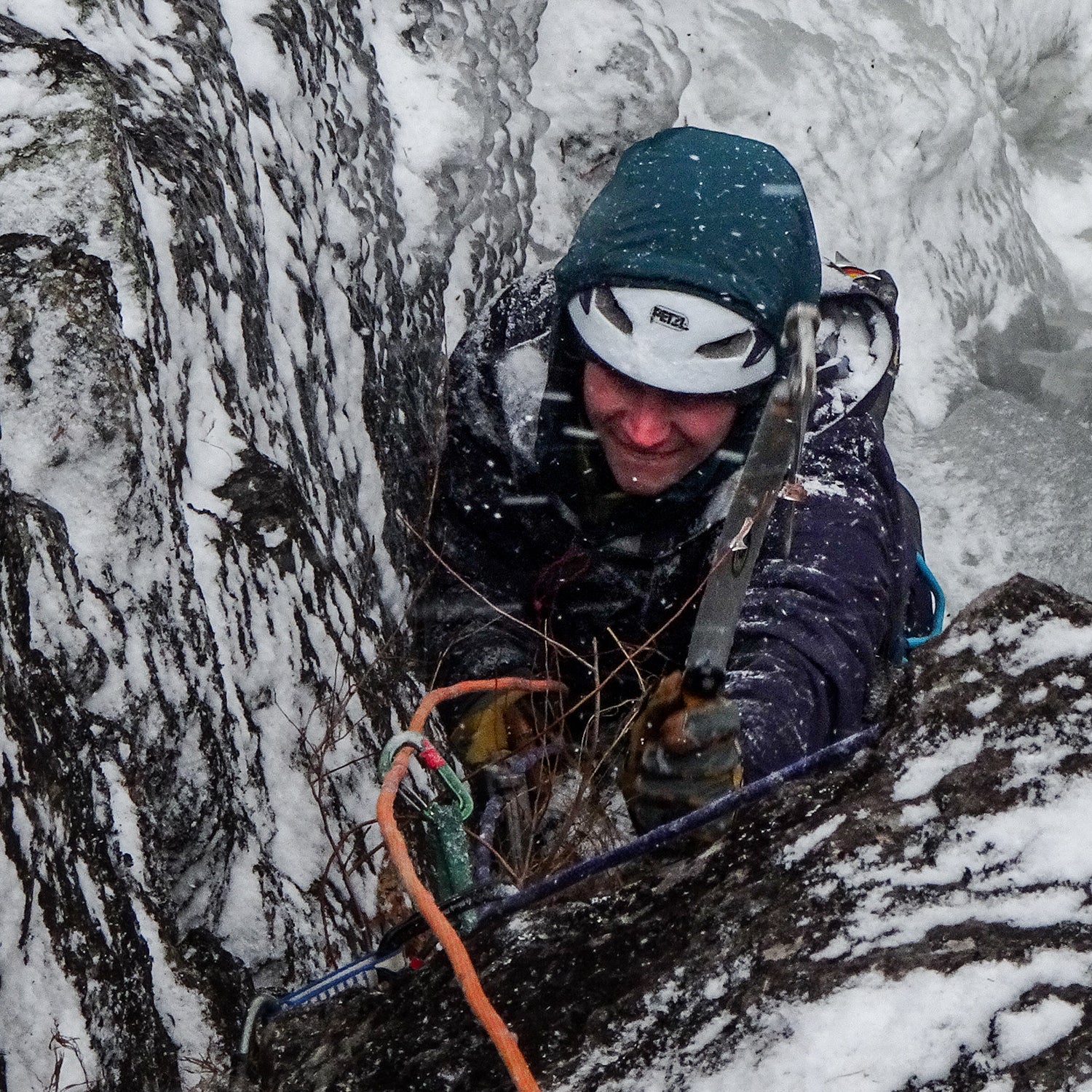 Climber in winter storm wearing a helmet