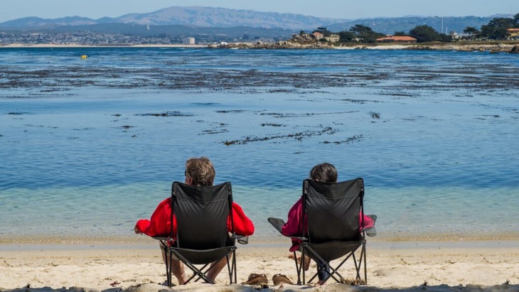 A couple looks out at Monterey Bay, California