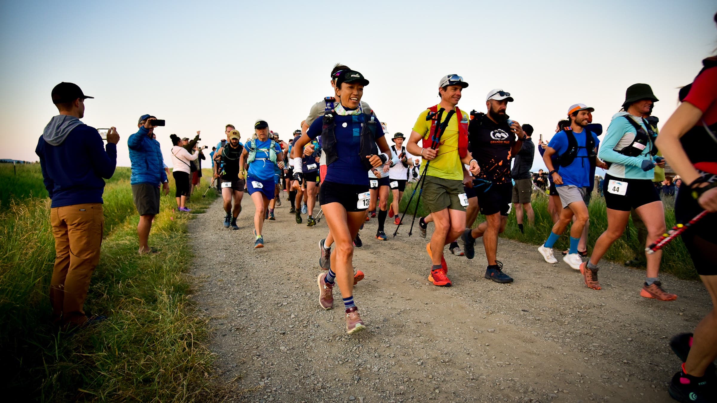 Dozens of runners start a race with spectators