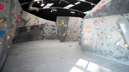 An empty wall in an empty climbing gym.