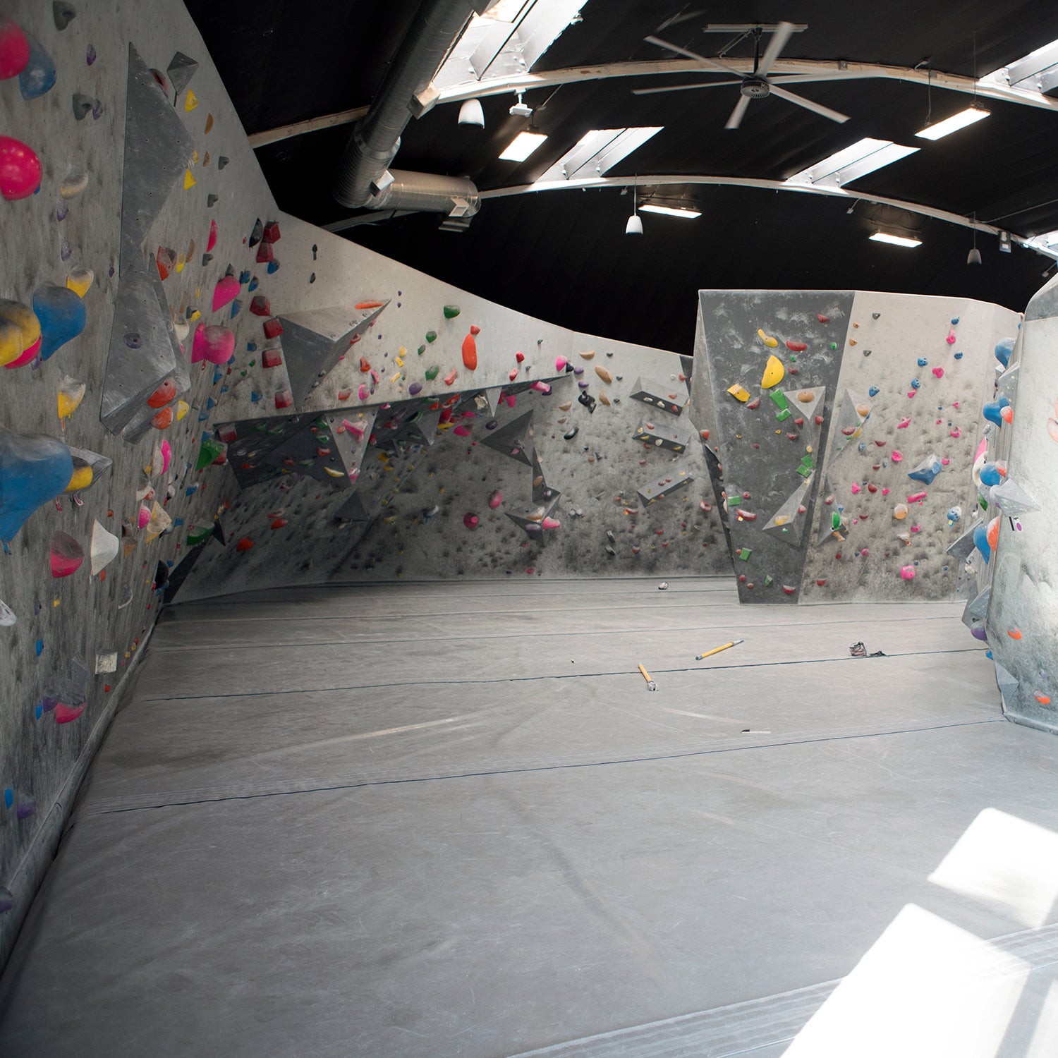 An empty wall in an empty climbing gym.