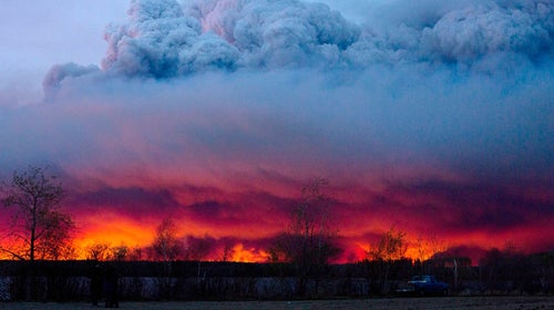 A wildfire moves towards the town of Anzac from Fort McMurray, Alberta., on May 4, 2016.