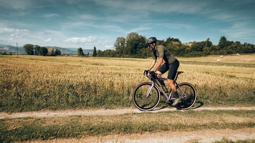 cyclist with gravel bike in italy in the countryside