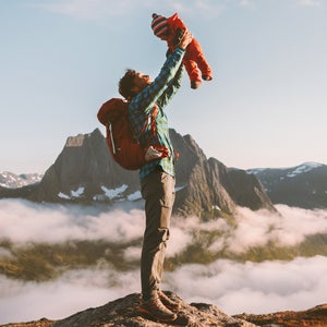 Father holding up baby in mountains happy family travel vacations with kids hike together active healthy lifestyle man and infant child outdoor recreation