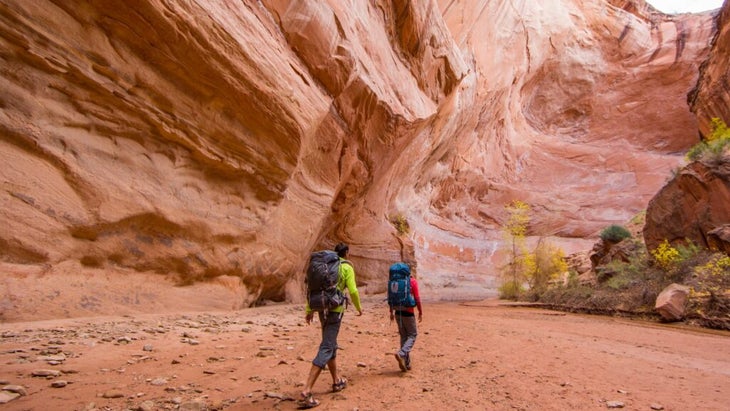Hikers heading through a slot canyon near St. George, Utah