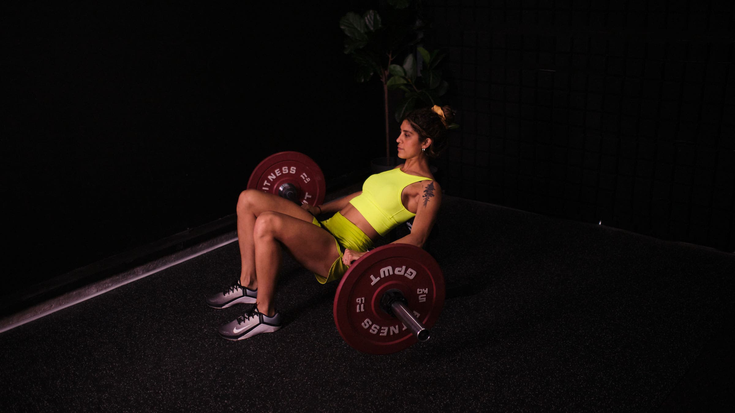 Woman demonstrates a hip thrust as a hip hinge exercise