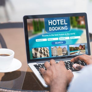 A man does an online search for a highly rated hotel