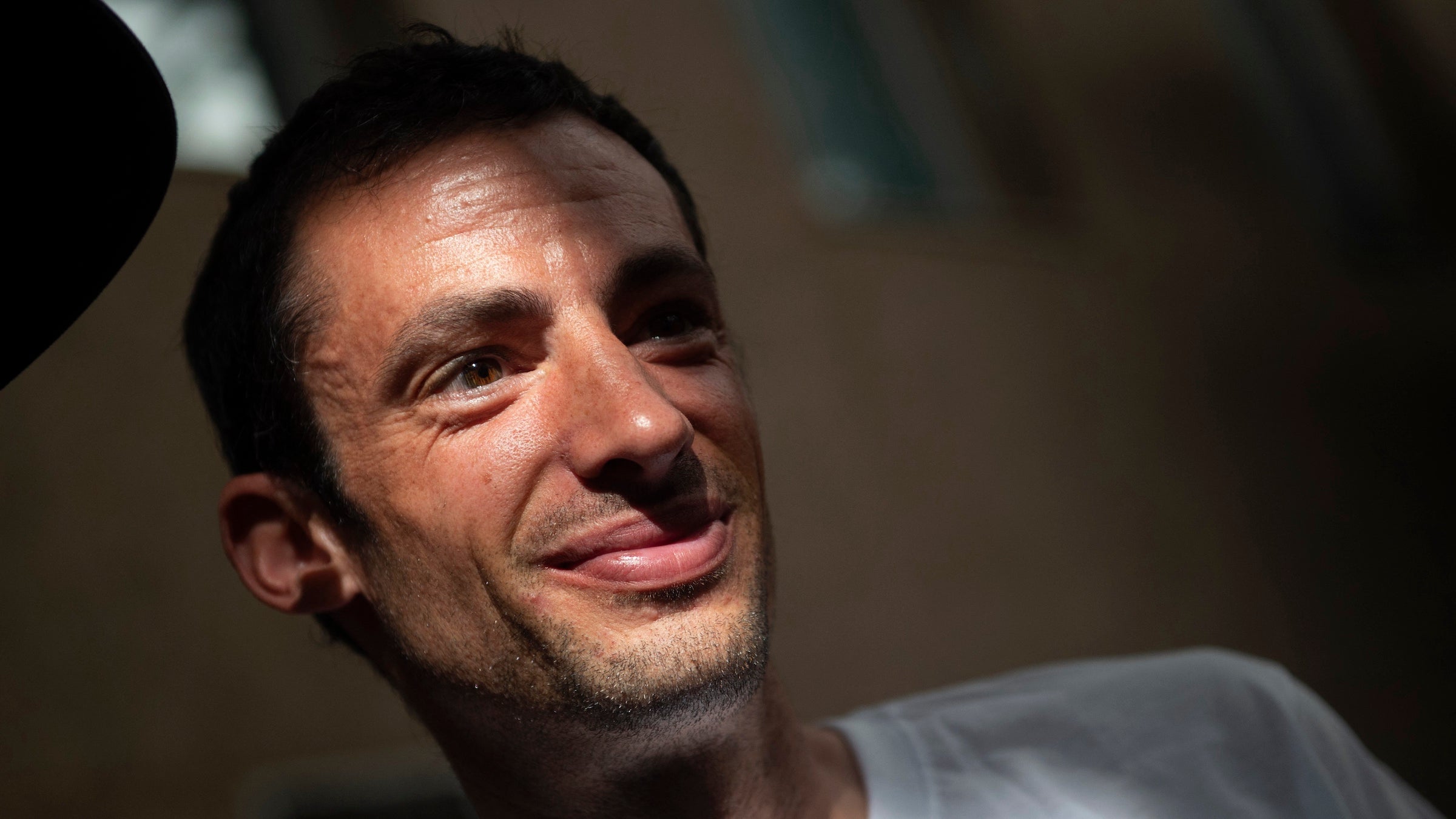 man in a white shirt in shadows