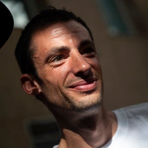 man in a white shirt in shadows