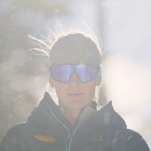 women with purple sunglasses and a jacket staring ahead