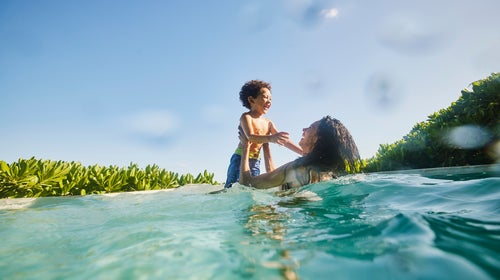 Mother and son playing in the pool