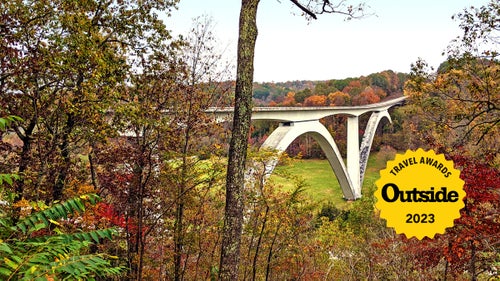 adventure travel places Double arch bridge on Natchez Trace Parkway, Franklin, Tennessee surrounded by fall colors.