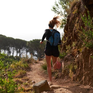 A woman runs on a beautiful trail