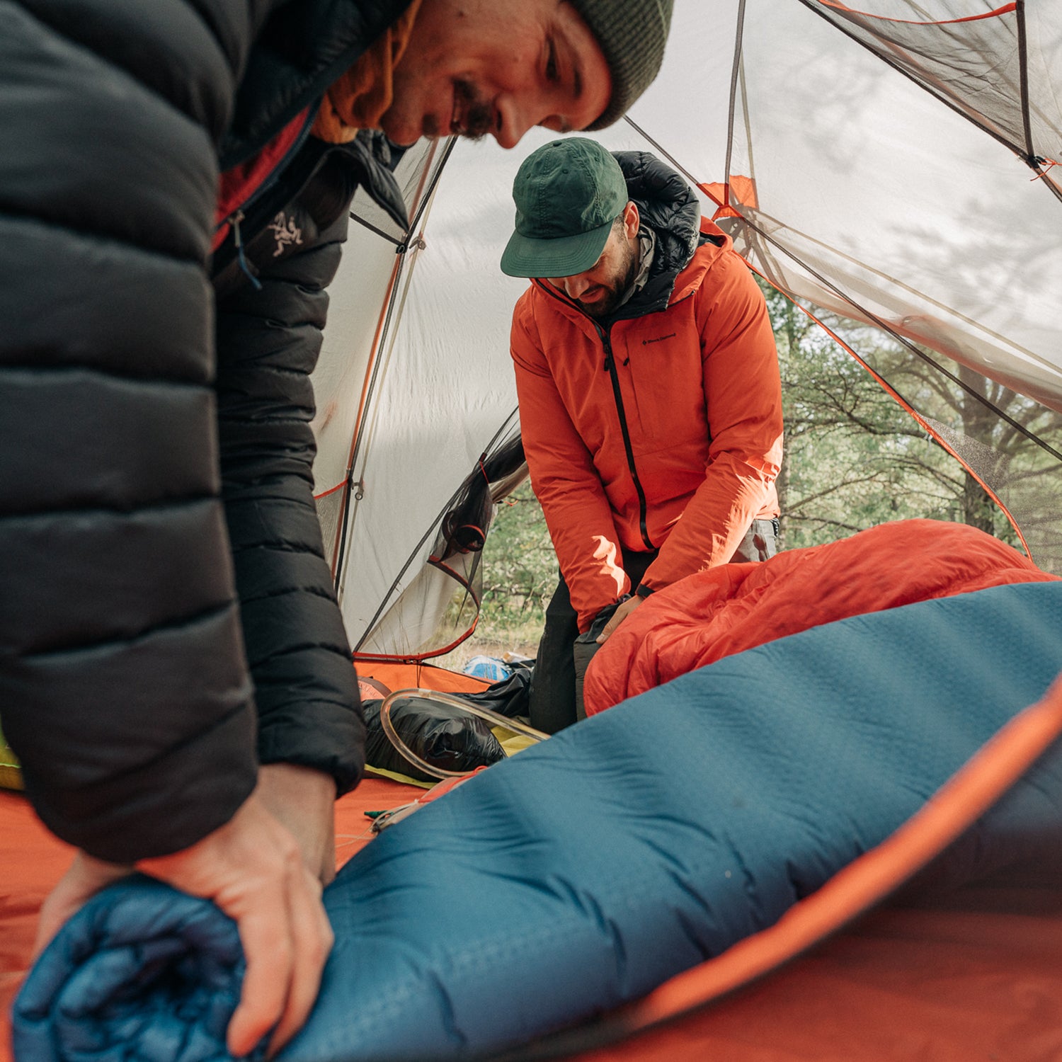 rolling up a sleeping pad in a tent